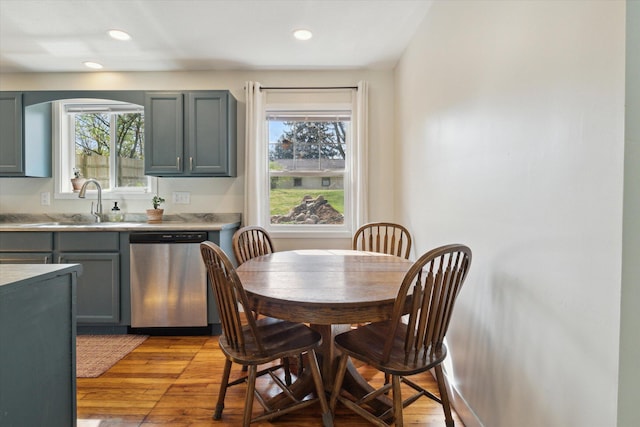 dining space with recessed lighting, a healthy amount of sunlight, and light wood-style floors