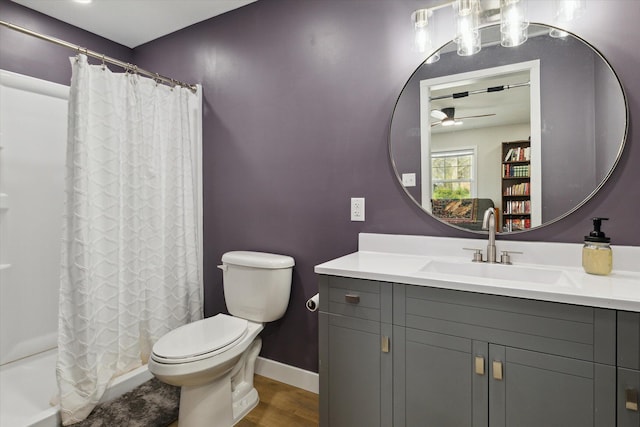 bathroom with vanity, a ceiling fan, curtained shower, and toilet