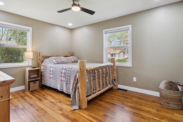 bedroom with recessed lighting, baseboards, and wood finished floors