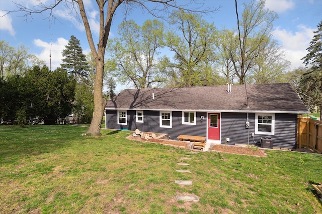 back of house with a yard, fence, and central AC unit