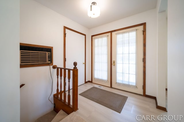 entryway featuring french doors, a wall mounted AC, wood finished floors, and visible vents
