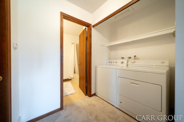 laundry room with light colored carpet, laundry area, and washer and dryer