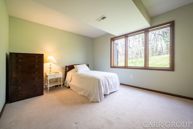 carpeted bedroom featuring baseboards and visible vents