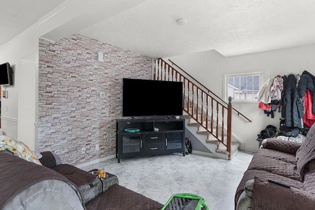 living area with stairway and a textured ceiling