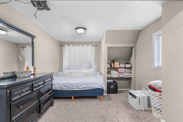 carpeted bedroom with a textured ceiling