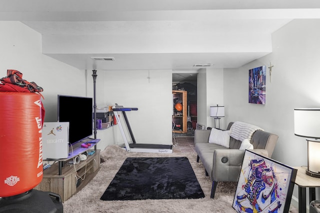 carpeted living area featuring visible vents
