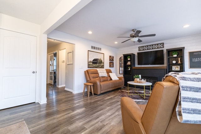 living room with a ceiling fan, visible vents, wood finished floors, baseboards, and recessed lighting