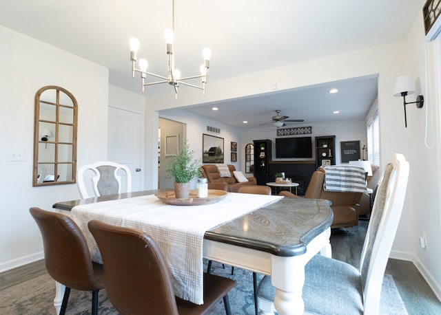 dining space with visible vents, baseboards, recessed lighting, dark wood finished floors, and ceiling fan with notable chandelier