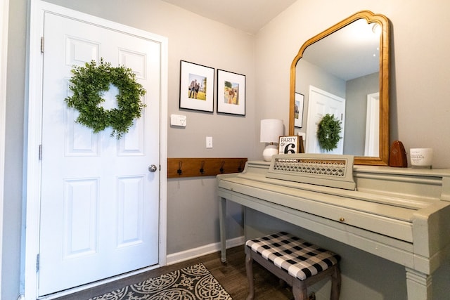 interior space with baseboards and wood finished floors