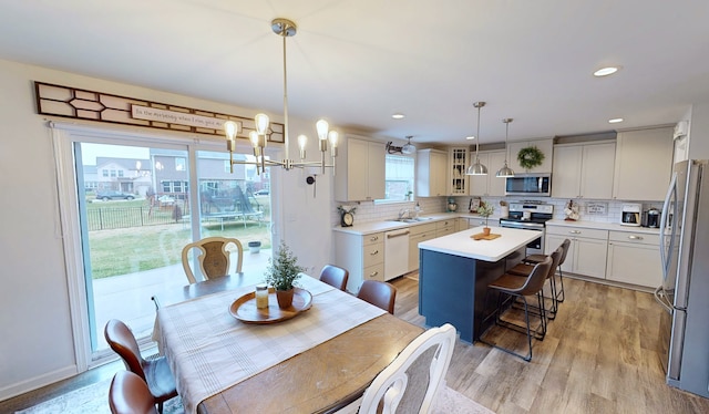 dining room featuring light wood-style floors, recessed lighting, and a chandelier