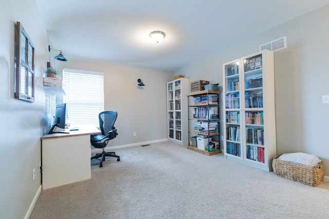 carpeted office space featuring baseboards and visible vents