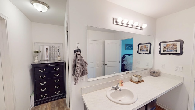 bathroom with vanity and wood finished floors