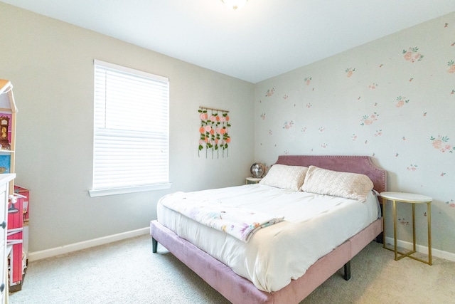 bedroom with baseboards and light carpet