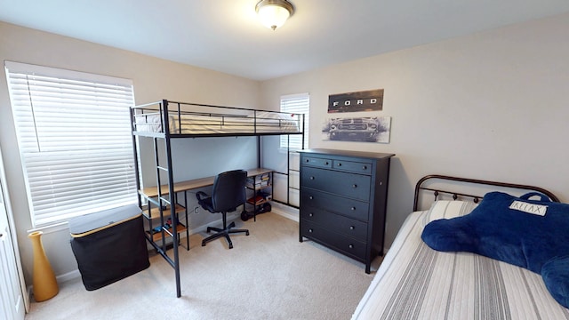bedroom with baseboards and carpet