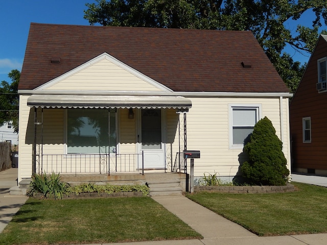 bungalow with a porch and a front yard