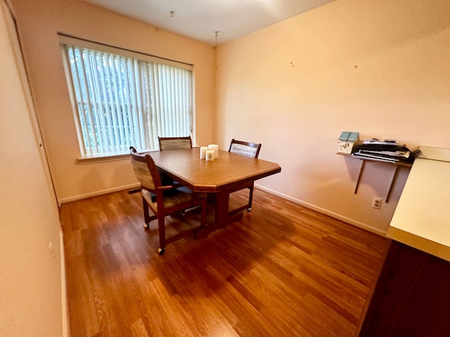 dining room with baseboards and wood finished floors