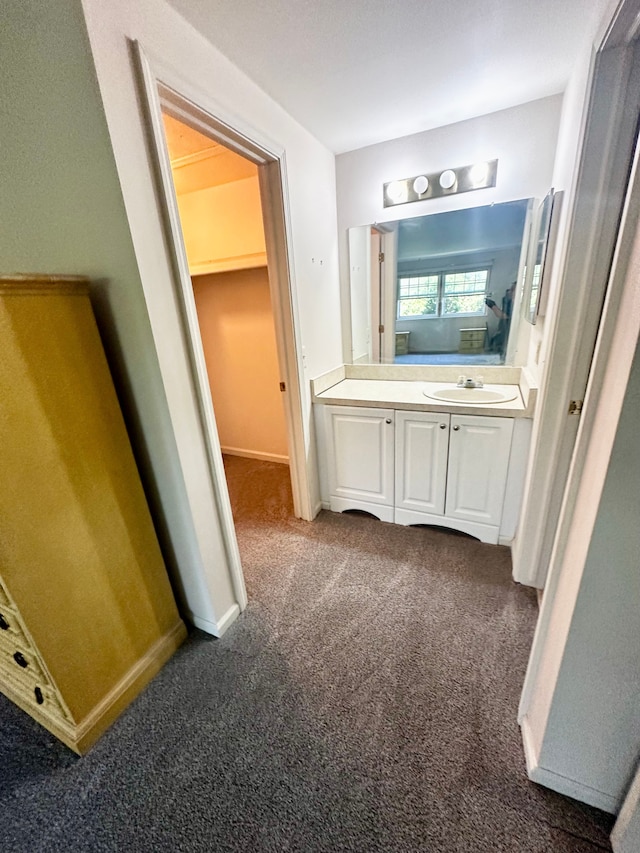 bathroom featuring vanity and carpet floors
