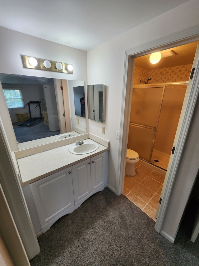bathroom with vanity, tile patterned flooring, toilet, carpet, and a stall shower
