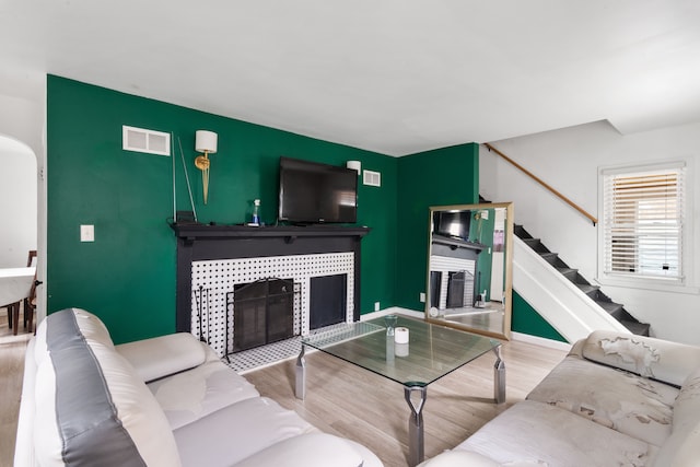 19165 Rutherford St, Detroit, MI 48235 - living area with stairs, a fireplace, visible vents, and wood finished floors