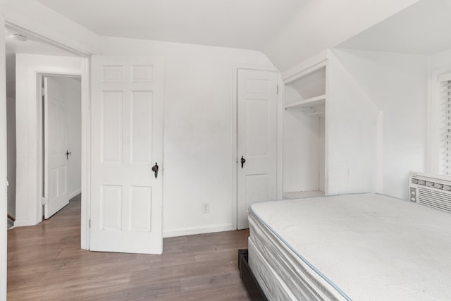19165 Rutherford St, Detroit, MI 48235 - bedroom with lofted ceiling, baseboards, a closet, and wood finished floors