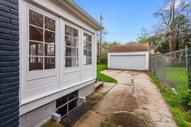 19165 Rutherford St, Detroit, MI 48235 - view of property exterior with fence, a garage, and an outbuilding