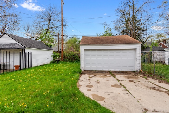 19165 Rutherford St, Detroit, MI 48235 - view of yard featuring an outdoor structure, a garage, and fence