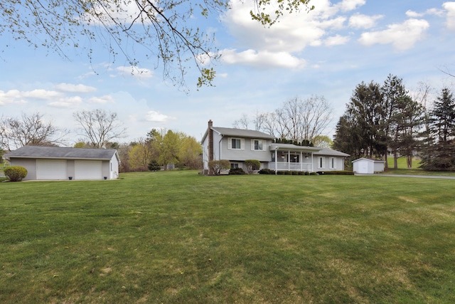 exterior space featuring an outdoor structure, a garage, a shed, and covered porch