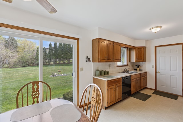 kitchen featuring decorative backsplash, light countertops, brown cabinets, a sink, and dishwasher