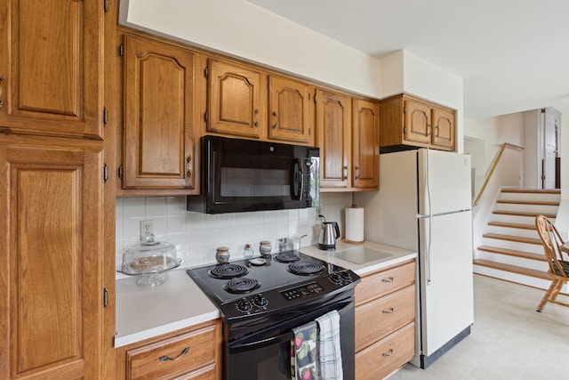 kitchen with light countertops, tasteful backsplash, black appliances, and brown cabinets