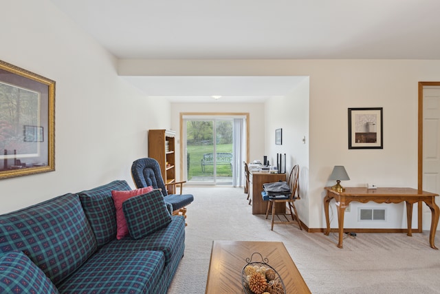 living area featuring baseboards, light carpet, and visible vents