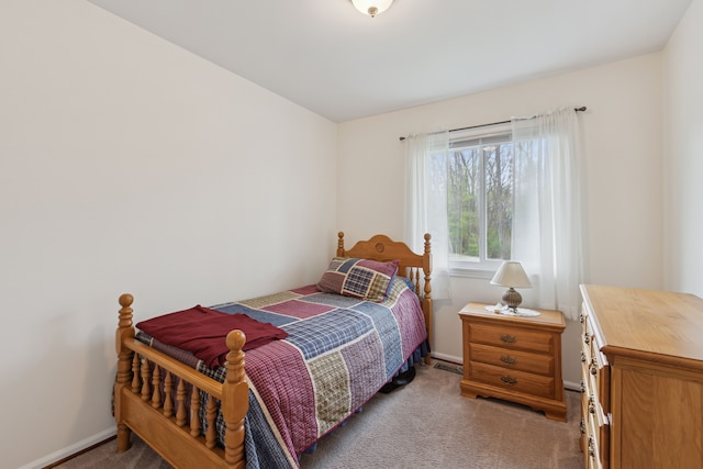 carpeted bedroom with baseboards and visible vents