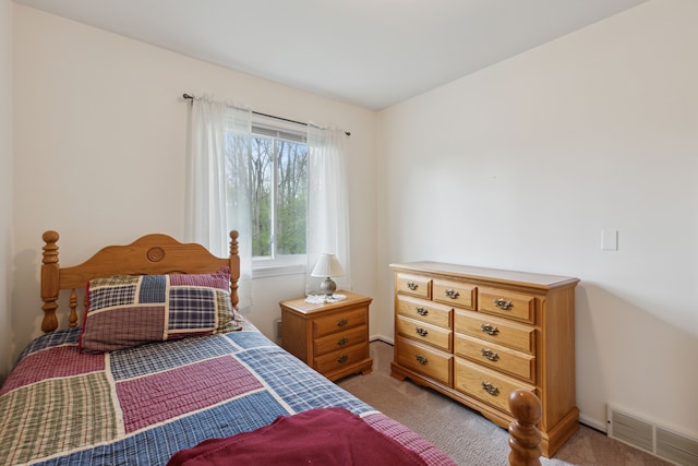 bedroom with light carpet and visible vents