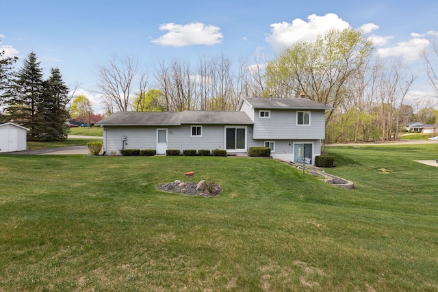 rear view of property featuring an outdoor structure, a shed, a chimney, entry steps, and a yard