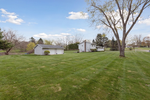 view of yard featuring an outbuilding and a garage