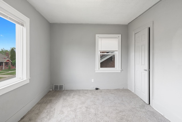 unfurnished bedroom with baseboards, visible vents, and carpet floors