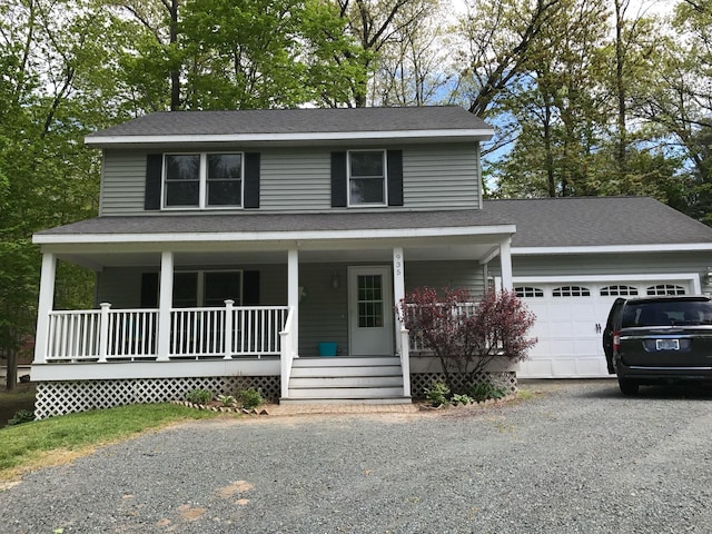 view of front of house with a garage, covered porch, driveway, and roof with shingles