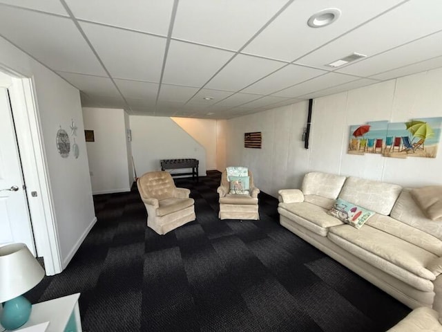 living room featuring baseboards, visible vents, and dark carpet