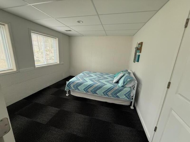 carpeted bedroom featuring visible vents and a drop ceiling
