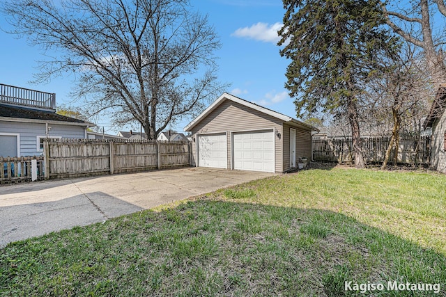 detached garage featuring fence