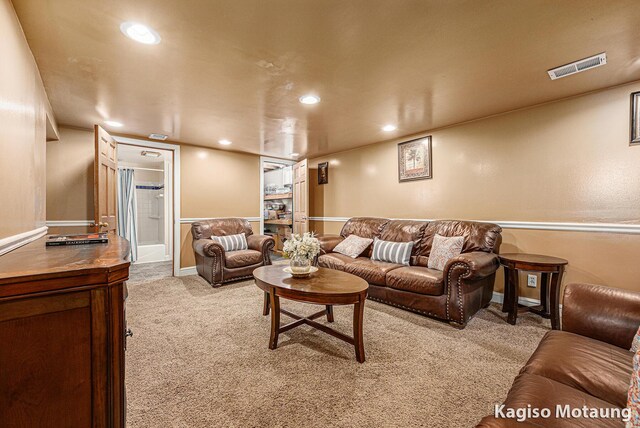 carpeted living area featuring recessed lighting and visible vents