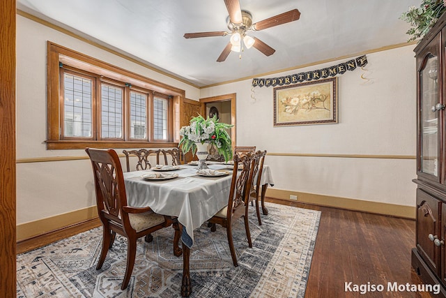 dining area with baseboards, ornamental molding, ceiling fan, and wood finished floors