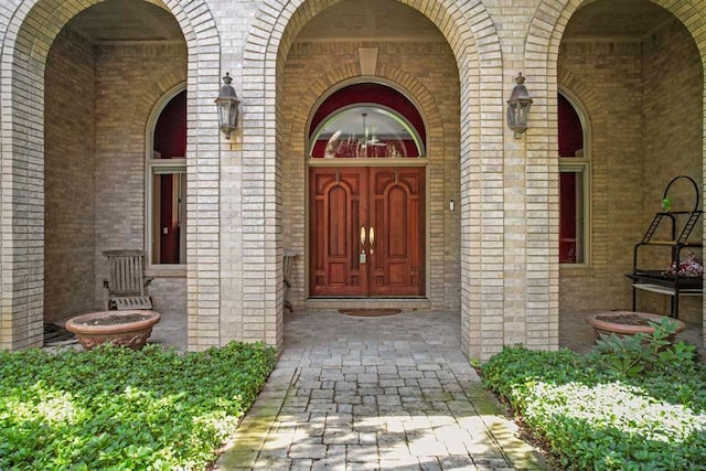 1293 Huntcliff, Milford, MI 48380 - doorway to property featuring brick siding