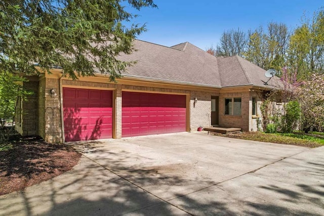 1293 Huntcliff, Milford, MI 48380 - view of front of house with an attached garage, concrete driveway, brick siding, and a shingled roof