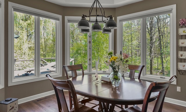 1293 Huntcliff, Milford, MI 48380 - dining room featuring a chandelier, baseboards, and dark wood-style flooring