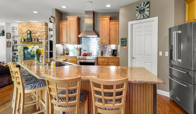 1293 Huntcliff, Milford, MI 48380 - kitchen with high quality appliances, wall chimney range hood, a sink, dark wood-type flooring, and decorative backsplash