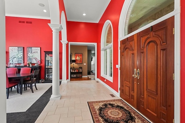 1293 Huntcliff, Milford, MI 48380 - foyer entrance with ornate columns, a towering ceiling, baseboards, crown molding, and light tile patterned floors