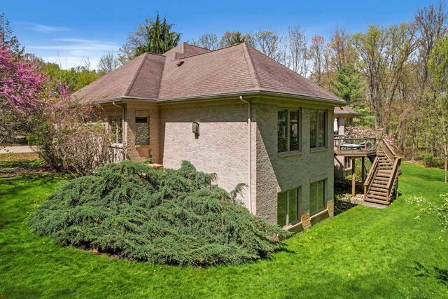 1293 Huntcliff, Milford, MI 48380 - view of side of property with stairs, a yard, a deck, roof with shingles, and brick siding