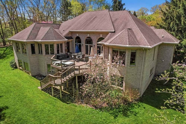 1293 Huntcliff, Milford, MI 48380 - rear view of house with a lawn, a wooden deck, a shingled roof, and brick siding