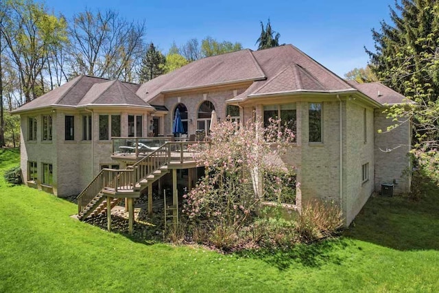1293 Huntcliff, Milford, MI 48380 - back of property with stairway, a wooden deck, central AC, a yard, and brick siding