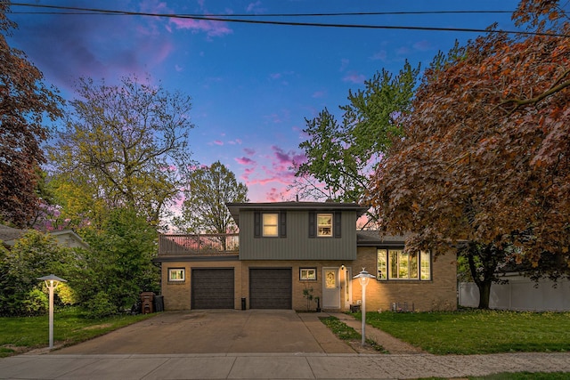 604 E N St, Owosso, MI 48867 - tri-level home featuring driveway, brick siding, and a garage